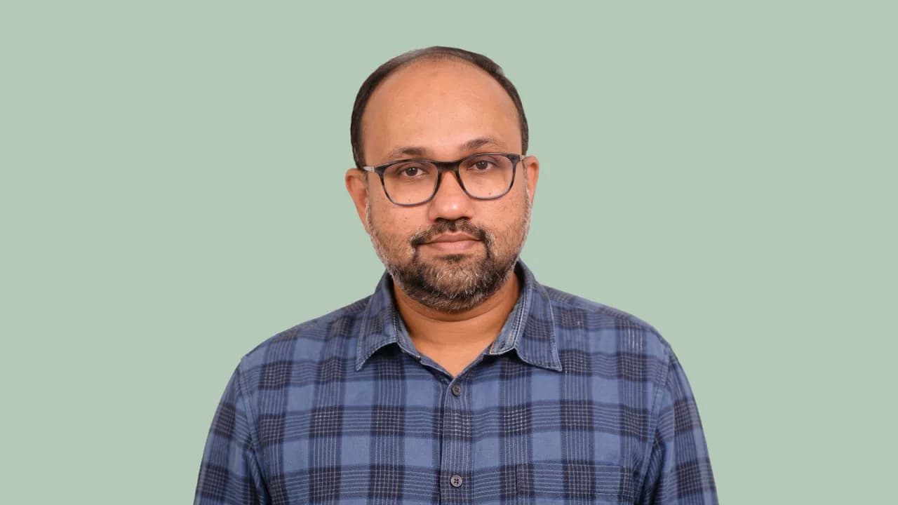 Hari Hara Sudhan Sridhar, Nippon Paint India's group lead for brand and marcomm, holding a microphone on a mint backdrop