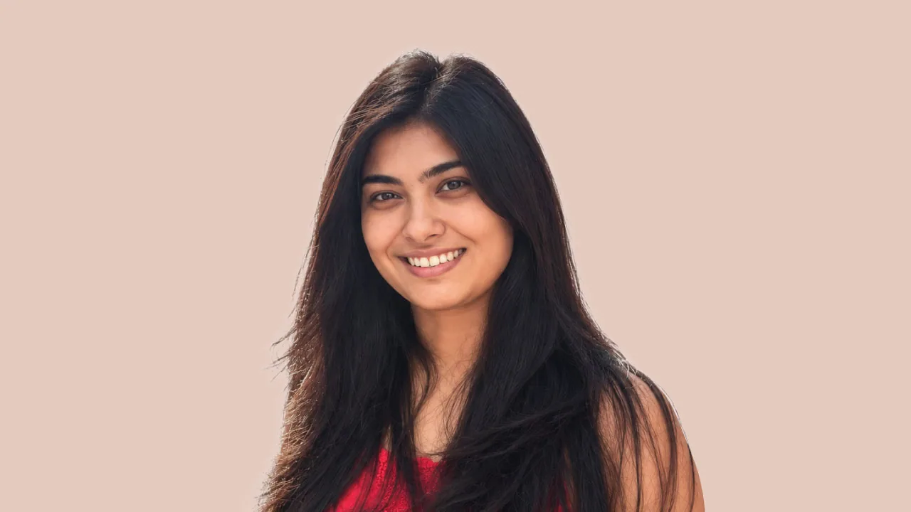 Isha Kapoor, senior vice president at Propagate India, smiling in a red top on a sunlit Mumbai street