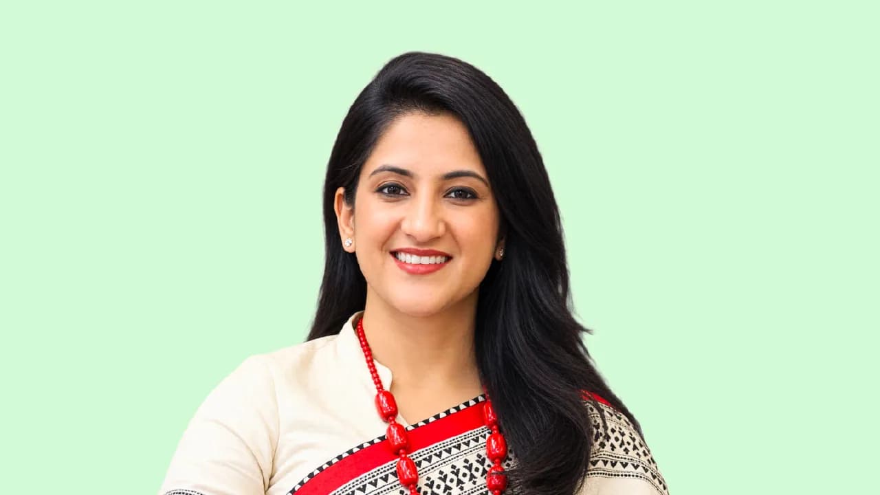 Black and white halftone cutout portrait of Ruchika Malhan Varma, chief marketing and customer officer at Mahindra Manulife, on a flat burnt orange background
