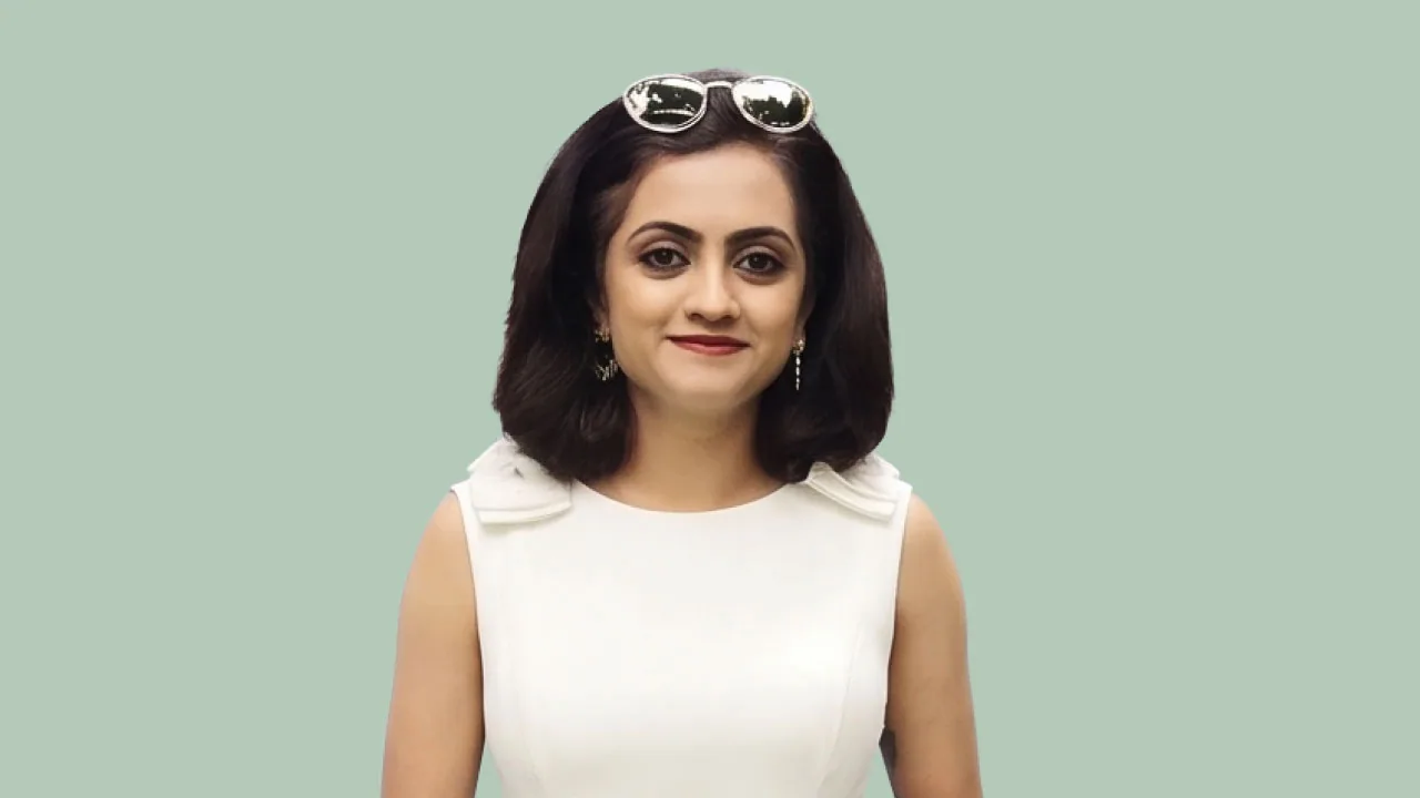 Vinita Sobarad, retail channel head for Rare Rabbit's exclusive stores at The House of Rare, smiling on a mint backdrop