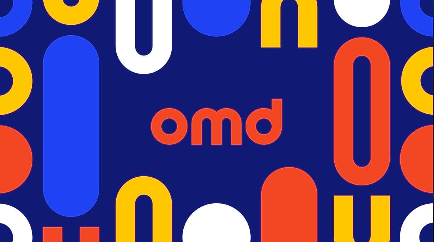 The OMD wordmark on a navy ground scattered with bold coloured shapes