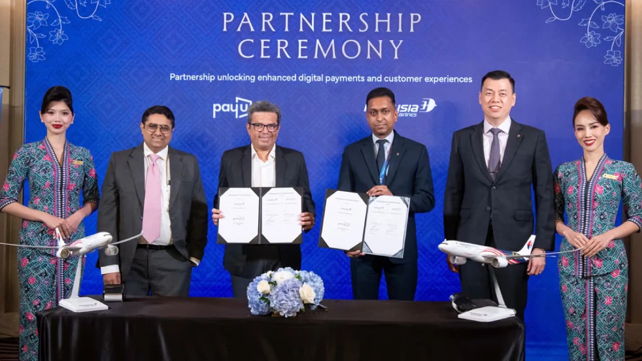 A paper aeroplane beside a payment card, for the PayU agreement with Malaysia Airlines on bookings by Indian travellers