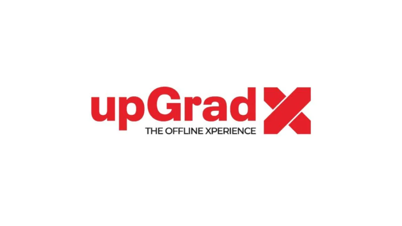 A classroom chair and a leather briefcase, as halftone cutouts, for upGrad rebranding its learning centres as upGrad X